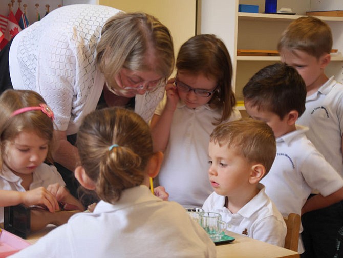 Primary school teacher Cecelia Snyder assists Maria Kozlowski as she puzzles where to place the lungs and other organs in her rubber figure. Snyder is retiring after teaching 3-6-year-old children at Old Town Montessori on S. Columbus Street for 20 years. 