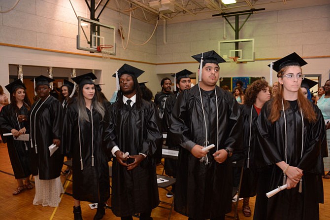 Quander Road School 2016 seniors listen to their principal declare them official graduates on June 7. 