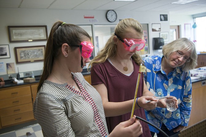 Middle School Science teacher Debbie Pakaluk works with eighth-grade students in the chemistry lab at Norwood School.
