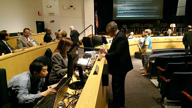 Sully District representative Tom Wilson (center) writes a new amendment to postpone an update to the Students Rights and Responsibilities document indefinitely.