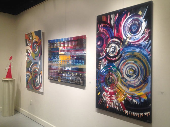 Several of the bold paintings by Reston resident Sherwood Gainer which are on display at ArtSpace Herndon in downtown Herndon. The exhibit will close on June 26.
