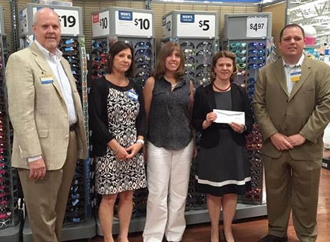 Our Daily Bread Board of Directors Member Catherine Read (second from right) and Programs Director Christina Garris (center) receive a grant check from Walmart Market Managers (from left) George Joyner, Leigh Belcher and Rodney Morrison at an award ceremony on May 26 at the Walmart Fredericksburg on Carl D. Silver Parkway.
