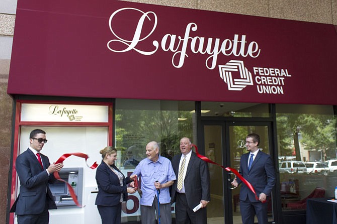 Lafayette Federal Credit Union opened a new full- service branch in Crystal City. From left: Brian Jester (Lafayette Federal), Kate Bates (president/CEO of the Arlington Chamber of Commerce), Norman Cohen (Lafayette board chair), B. John Farmakides (president/CEO Lafayette Federal) and Lucas George (Lafayette Federal).
