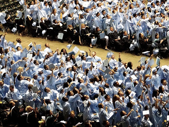 Graduates toss their caps in the air following the graduation ceremony.
