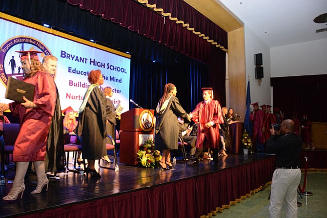 Bryant Principal Tanganyika Millard hands out the diplomas.