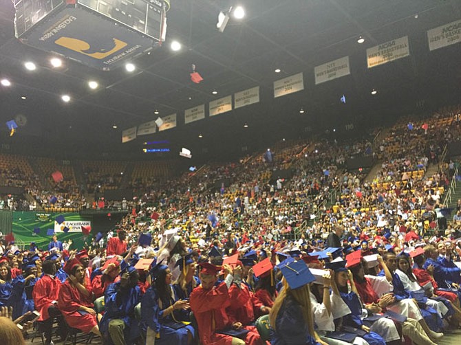 T.C. students throw their caps into the air at graduation
