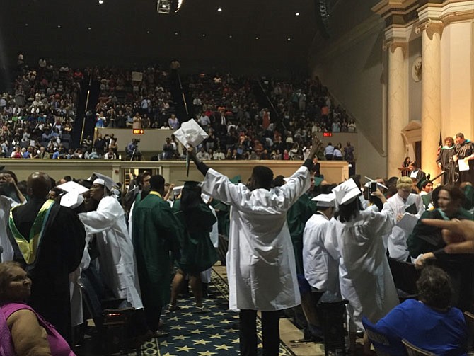 Students cheer after graduation ceremony
