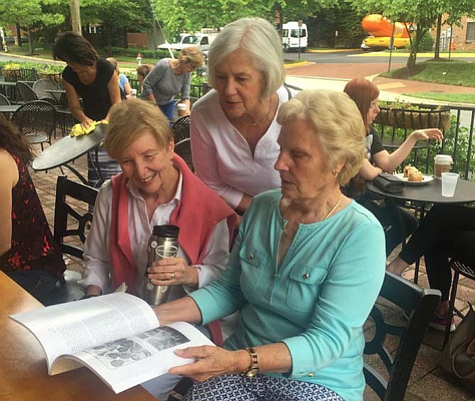 Carole L. Herrick shows her new book, “Hickory Hill: McLean Virginia: A Biography of a House and Those Who Lived There” to friends Pam Lucey and Mary Ludden at Greenberry’s Coffee Co. in McLean.
