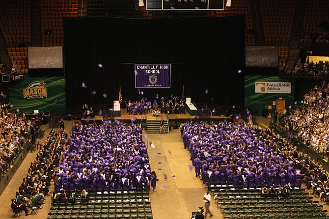Chantilly High School graduating class of 2016 toss their caps in the air upon graduating.
