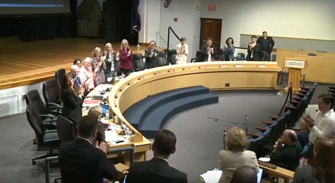 The Fairfax County School Board members applaud Dr. Karen Garza after renewing her contract as superintendent for four more years.