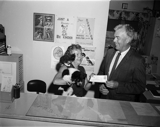 AWLA shelter worker and her furry friends accept a check for a planned addition to the Alexandria animal shelter at 910 S. Payne Street. Photo from June 1969 Alexandria Gazette.
