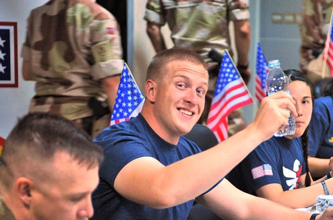 A great Fourth of July: American troops open packages from Reston Chorale.
