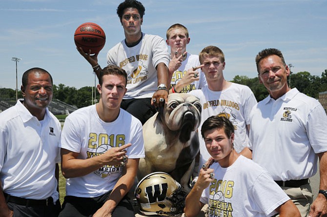 Westfield High School juniors Sean Eckert,  Rehman Johnson  and seniors Cole Huling, Hank Johnson and Tyler Scanlon with their two state championship rings along with basketball head coach Doug Ewell and football head coach Kyle Simmons. The five student athletes played on the Virginia State 6A champion football and basketball teams at Westfield.
