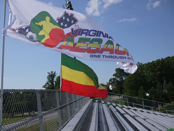 Ethiopian and AESAONE flags fly above the bleachers. 

