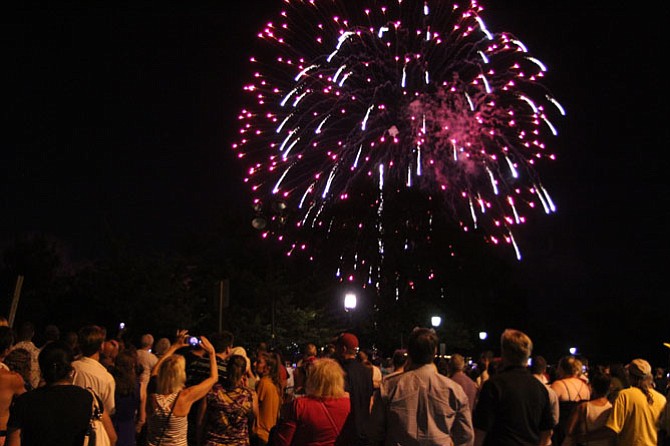 People capture the fireworks display on cell phones and cameras during Alexandria's birthday celebration July 9, 2016. 

