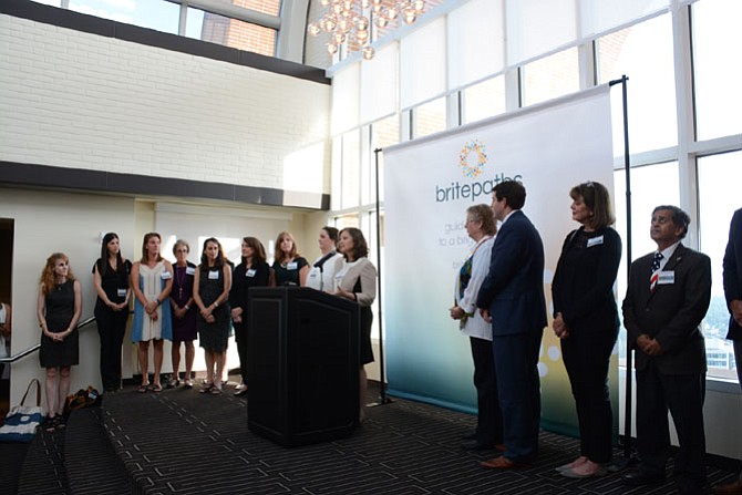 Executive Director Lisa Whetzel (center) announces the name change of Our Daily Bread to Britepaths at Tower Club Tysons Corner.