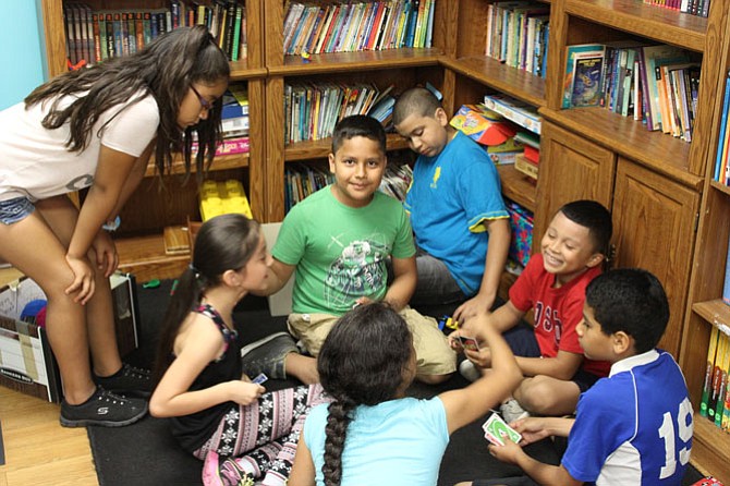 Students in Community Lodgings’ summer learning program play "Uno" during a short break.
