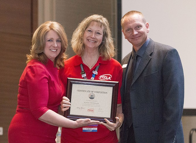 Lanier teacher Susan von Schaack, center, is honored by Sandy Spavone, FCCLA executive director, and Peter Martinovich, an educational consultant at Goodheart-Willcox.