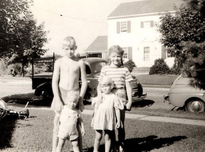 Luhrs children: Back row -- John and Meredith, Front row -- Warren and Linda, with the truck and its lumber rack in background.
