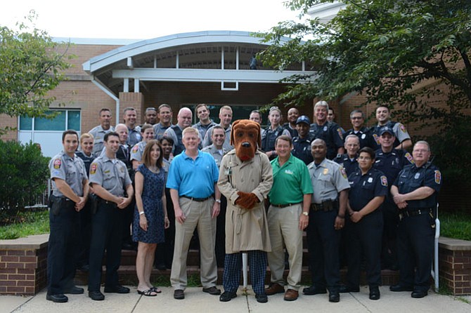 (Center, going right) Delegate Eileen Filler-Corn,D-41, Supervisor John Cook, R-Braddock, McGruff the Crime Dog and Supervisor Pat Herrity, R-Springfield, with officers in front of the West Springfield District Government Center before heading out for the 2016 National Night Out to interact with community members on Aug. 2.

