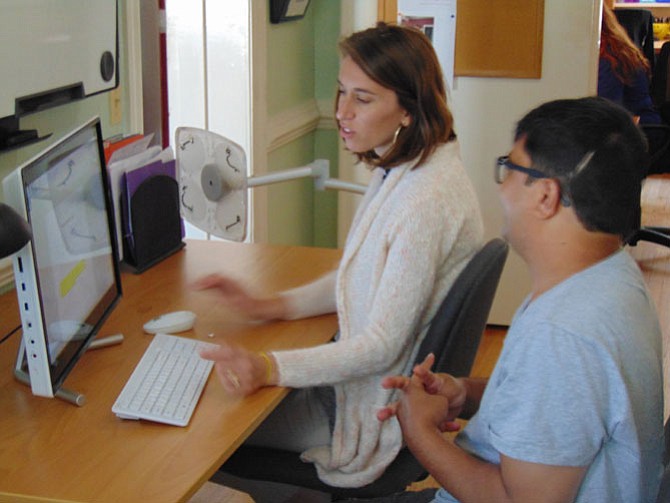 Rachel Petrie, Brain Injury Services unit coordinator, works with Suray Sharma to develop basic office skills.
