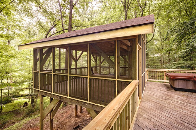 Re-built by Hopkins & Porter Construction, this screened porch offers serene views of wildlife.
