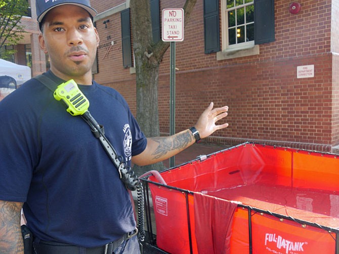 Durant Cephers illustrates a portable, folding water tank filled with about 600 gallons of water. He says this would be used in a rural area where they had no fire hydrants or in Iraq where he served as a firefighter from 2008-2011. 
