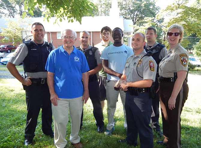 Church, FACETS and law-enforcement personnel gather for a photo in Ragan Oaks.