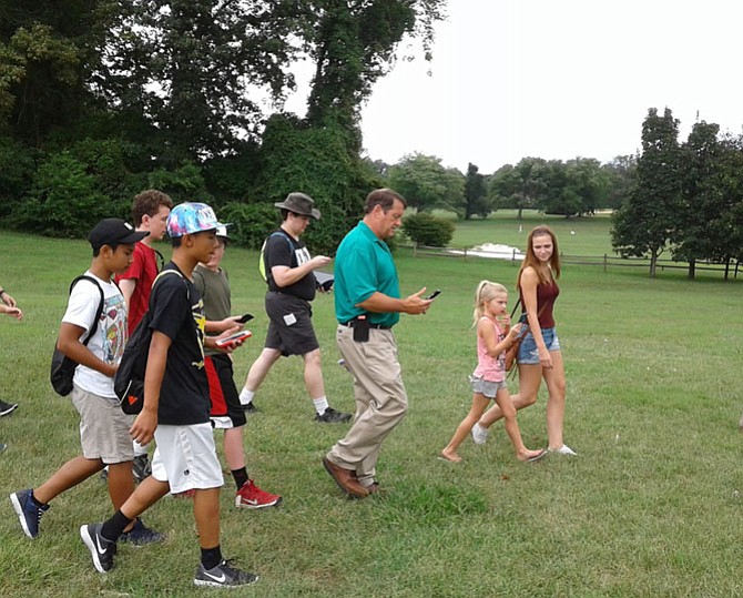  Supervisor Pat Herrity [R-Springfield], center, leads the first of many PokéQuests Aug. 5 in Burke Lake Park at a ‘Pokémon GO’ safety awareness event he co-sponsored with Fairfax County Police.
