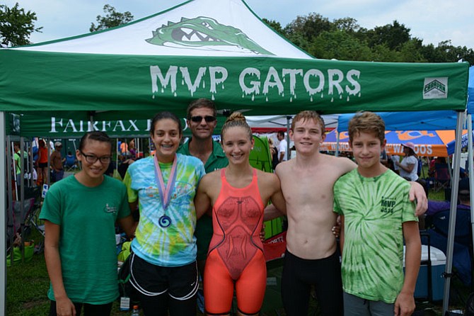 From left, Mount Vernon Park Gators Sheridan Phalen, Juliana Skopp-Cardillo, Cassidy Bayer, Brian McNamara and Donovan Kovalsky spend time in their team area with longtime coach Paul Makin, rear.
