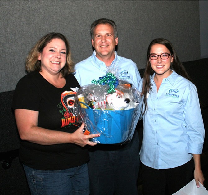 Brooke Holdeman (left) won a gift-basket raffle during Computer Services Unlimited’s “Customer-Appreciation / Get-To-Know-CSU” event earlier this month. At right are CSU’s Chuck Sherman and Heather Fernandez. 
