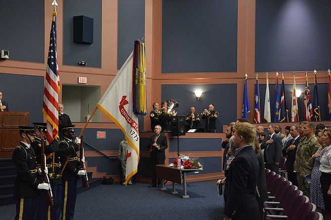 A color guard from the Third Infantry Regiment “Old Guard” presents the flags while the U.S. Army Band “Pershing’s Own” Brass Quintet performs the U.S. national anthem.