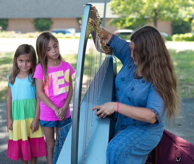 Ellen James, Celtic Harpist, with avid fans at the Great Falls Farmers Market.
