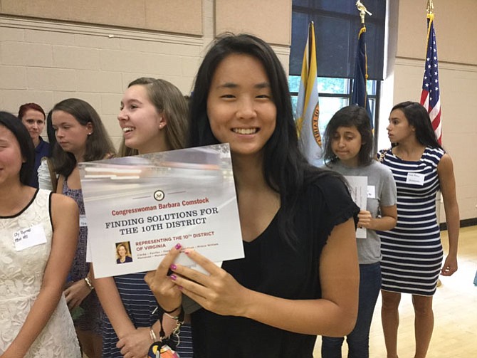 Karis Yu, a rising junior at Oakton High School, holds the certificate she received during the Aug. 17 session of Comstock’s  Tenth Congressional District Young Women Leadership Program.
