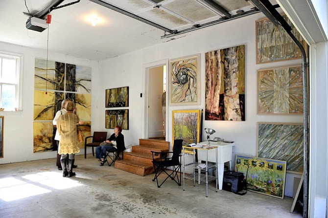 The garage of abstract painter Jo Fleming becomes a makeshift exhibition hall during a past Studio Tour. Studio Tour, a self-driving event to meet artists in their home environments, is the signature event of Great Falls Studios, and involves thousands of visitors over a weekend each fall. This year’s tour is October 14 to 16.
