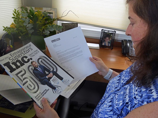Heidi Parsont, president and CEO of TorchLight Hire, holds up a copy of the September issue of Inc. Magazine that lists her company as number 621 out of 5,000 of the fastest growing private companies.
