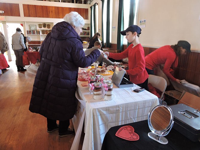 Dylan Kurtz, Steven's younger brother, assisting a customer at Great Falls Farmers Market.
