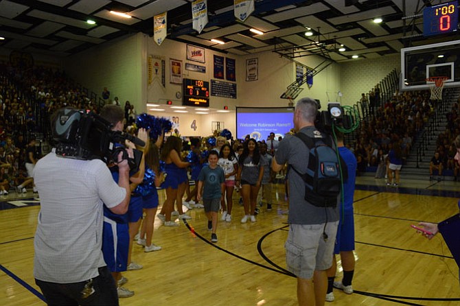 At Robinson Secondary School, the entire incoming seventh grade class first met separately in the auditorium to learn the fight song while the rest of the student body assembled in the gymnasium.