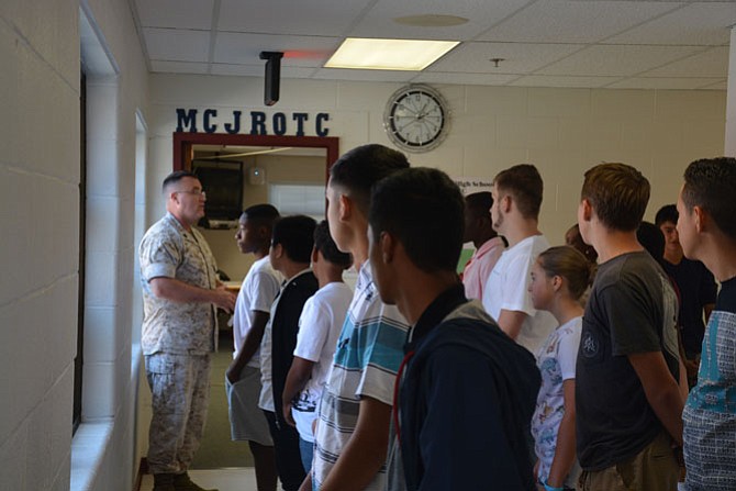 Gunnery Sgt. Gordon (left) welcomes new cadets for first-year Marine JROTC class at Mount Vernon High School on the first day of classes, Sep. 6.