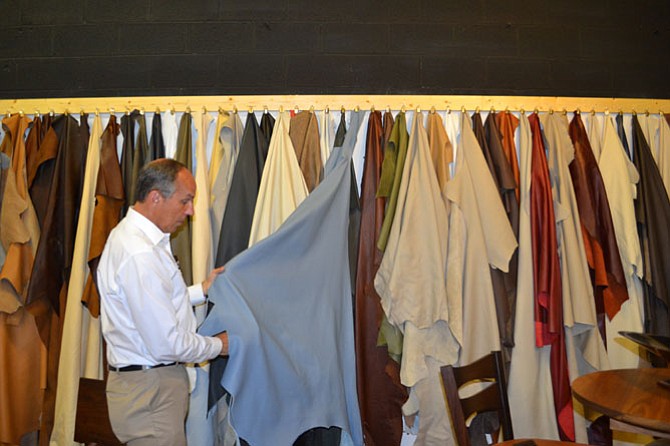 John Smith of Willem Smith FurnitureWorks shows examples of leather used for the seating he creates.
