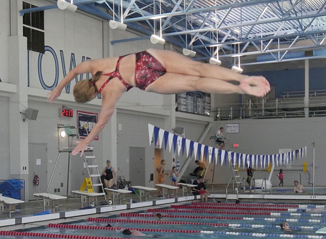 Carol Mackela adds a half twist to her dive at the Senior Olympics. Mackela started diving again after a 33-year hiatus from the sport. She heard from a college diving partner that the partner was doing well, "so I decided to give it a try again, too. She is deceased now so every dive I do for Mary." Mackela, who lives in Arlington, says that she and Karen Alderman are undefeated national champions in master synchronized swimming in their age category but this isn't an event offered in the NVSO competition.
