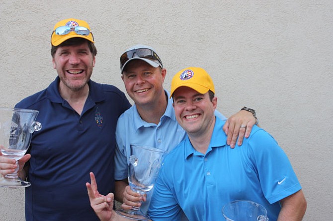 Bill Hummel, Greg Jacobson and Tom Lapato celebrate Sept. 9 as winners of the third annual Patriot Day Golf Classic sponsored by Belle Haven Country Club. Not pictured is Chris Meyer.
