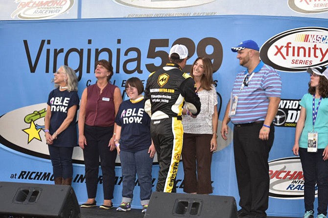 Del. Eileen Filler-Corn, Natalie and Catherine Beck, and Virginia 529 CEO Mary Morris shaking the hands of the drivers before the race. 
