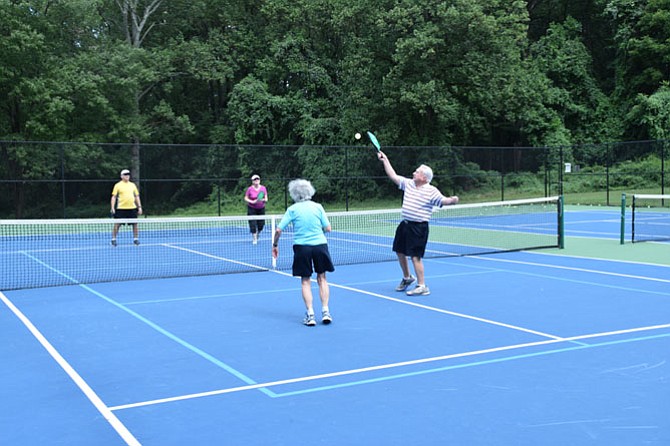 Pete McCloskey and spouse Louise return the ball to Tom and Eileen Culligan on the newly lined pickleball courts in McLean Central Park.
