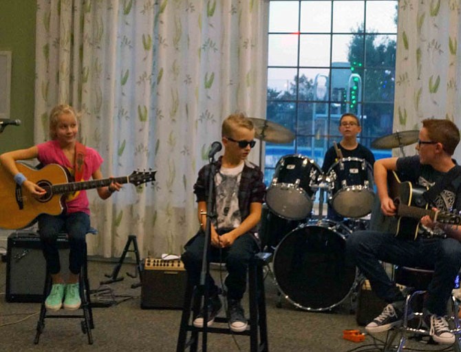 From left: Maddie Powell (guitar), Anderson Bonanno (vocals), Christian Moreno (drums) and Ryan Bonanno (guitar) sit down for a few slow tempo songs during the concert.