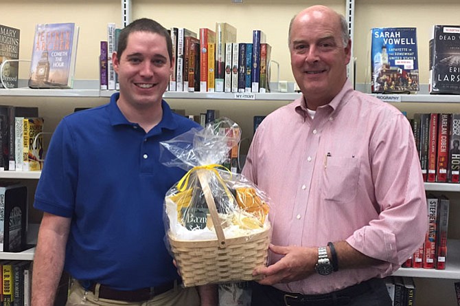 From left -- Assistant Manager James Cullen and winner Ray Miller with the gift basket. 
