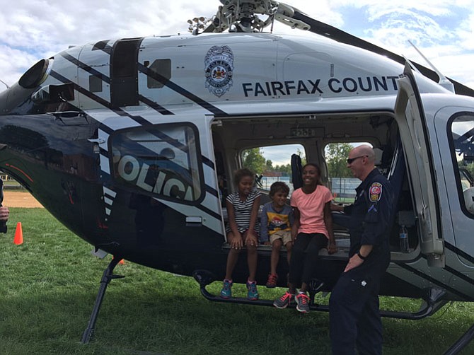 Aisha Justilien, 8, and her siblings Daniel, 4, and Maya, 11, of Vienna, giggled as they sat in the Fairfax County police helicopter.
