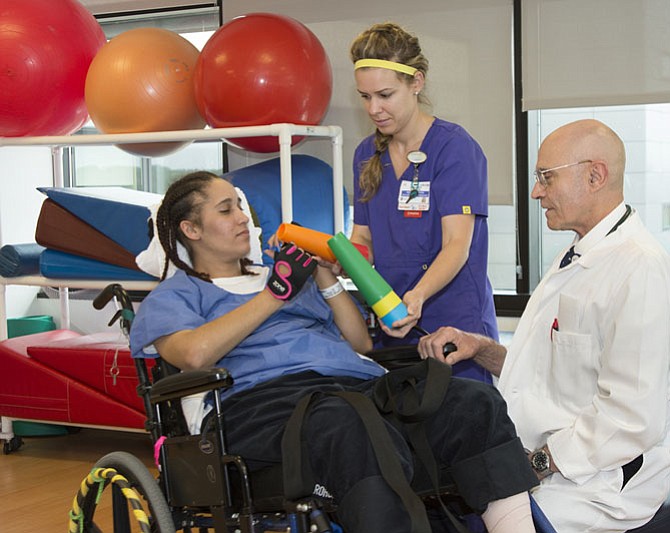 Dr. Roger Gilsofi, medical director, Inova Mount Vernon Rehabilitation Center, with Occupational Therapist Ashley Meadows working with patient Pollyanna Resto Corino inside Mount Vernon Hospital's 5th floor rehab therapy gym area. This is part of the new rehab therapy area of the Mark and Brenda Moore Patient Tower which opened in 2014.

