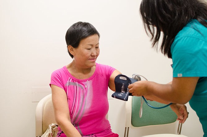 Patient Mung gets her blood pressure checked at the Arlington Free Clinic. 
