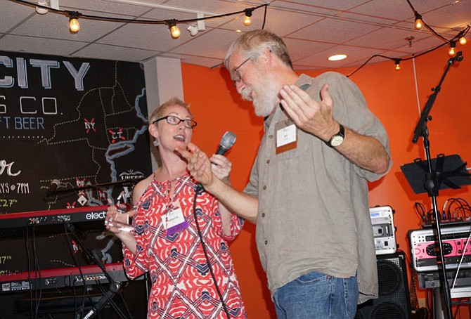 Bill Berridge, right, is presented with Rebuilding Together Alexandria’s Volunteer of the Year Award from RTA president Katharine Dixon.
